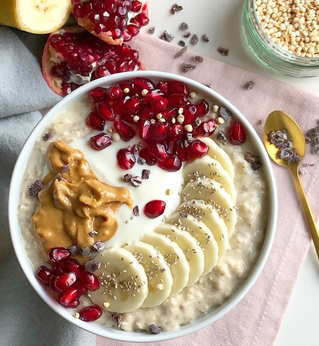 Nourishing postpartum oatmeal bowl with banana slices, seeds and peanut butter